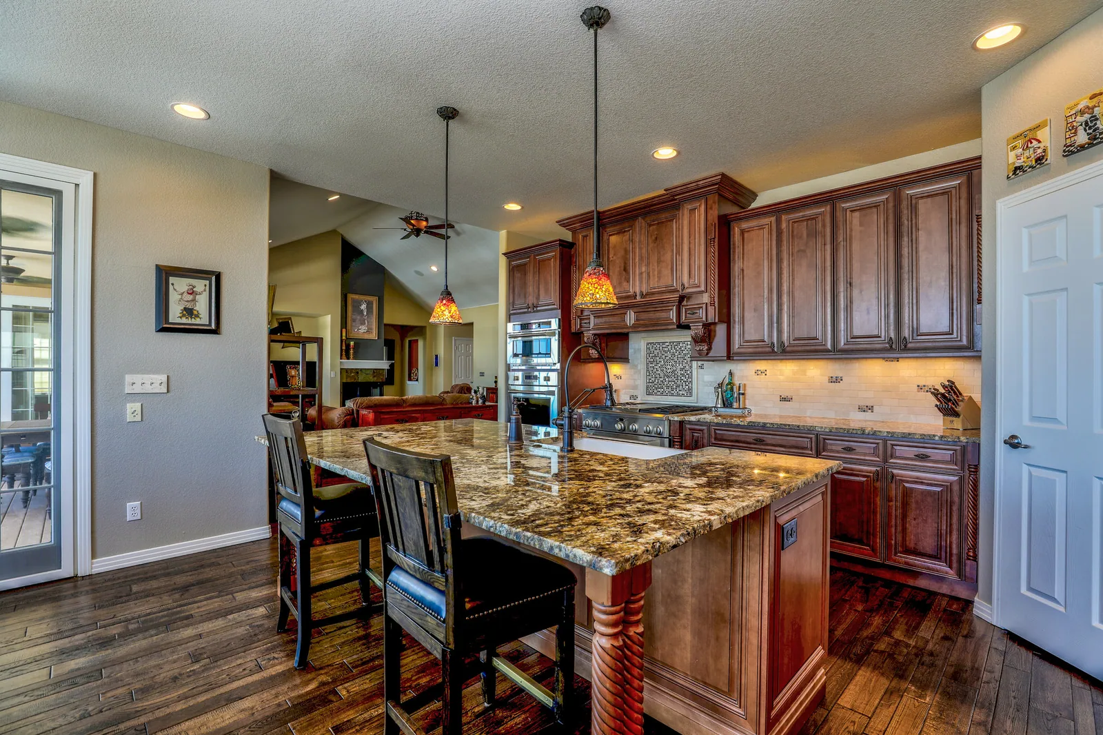 Before: a dated kitchen with wooden fixtures, granite counters and a closed-in layout